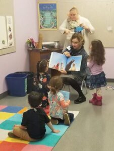 Pre-K class leaders read to children