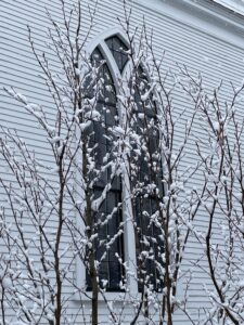 Exterior photo of North Parish window through snow covered branches