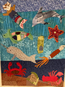 a coming of age quilt, created by north parish youth featuring various underwater sea-life