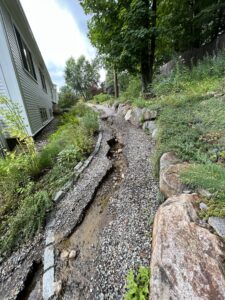Photo of washed out gravel path at North Parish due to flooding.