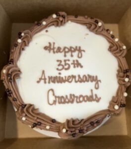 Photo of a cake, written in frosting it says "Happy 35th Anniversary Crossroads"