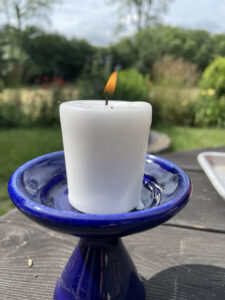 Photo of white candle in a blue chalice
