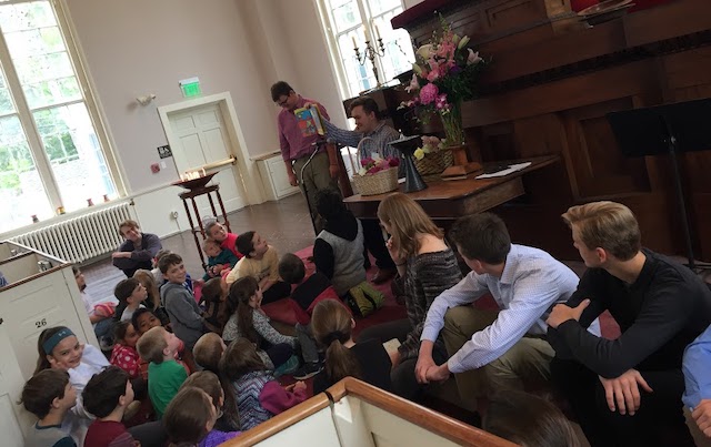 Children gather at the front of the sanctuary for story time