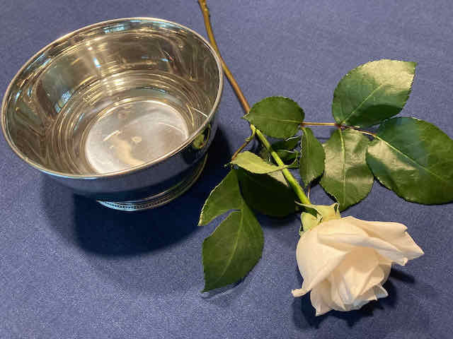 A rose by Lee's silver bowl used for child dedications