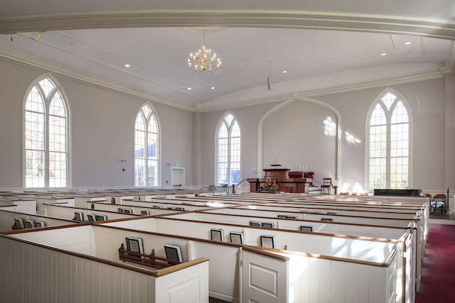 View looking across the pews from the back of the sanctuary, light from the windows casting reflections on the wall