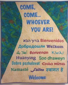 Come, come, whoever you are banner with Welcome in multiple languages
